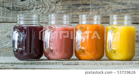 Slection of fresh fruit juices in jars Slection of fresh fruit juices in jars 53729626