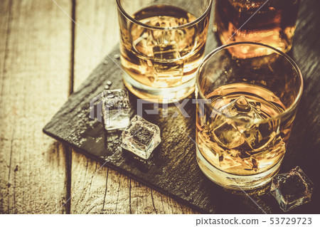 Whistey with ice in glasses 53729723