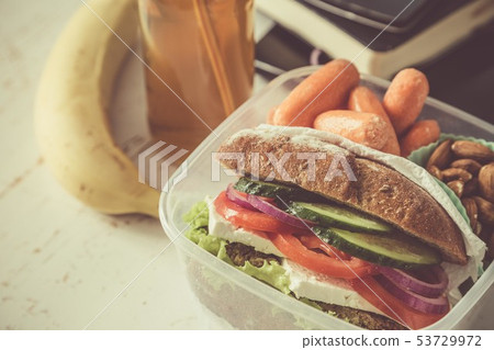 Vegan sandwich in lunch box with carrots and nuts 53729972