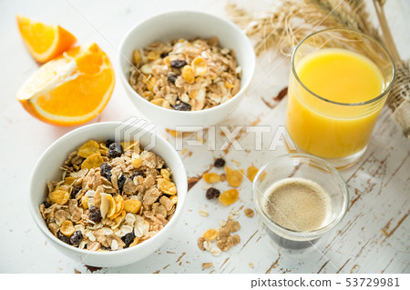 Breakfast - muesli and fruits on white background 53729981