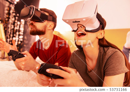 Smiling couple being very attentive during a game Smiling couple being very attentive during a game 53731166