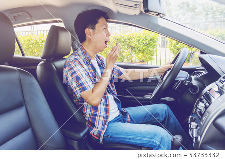 Tired young asia man driving his car 53733332