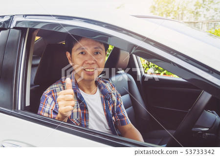 Asia man smile happy and drive car Asia man smile happy and drive car 53733342