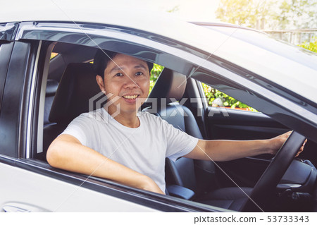 Asia man smile happy and drive car Asia man smile happy and drive car 53733343
