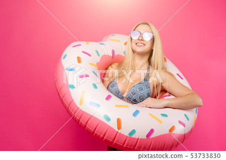 Image of smiling girl in swimsuit sunglasses with inflatable donut for swimming Image of smiling girl in swimsuit sunglasses with inflatable donut for swimming 53733830