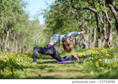 Photo of girl with arms raised practicing yoga in woods Photo of girl with arms raised practicing yoga in woods 53734090