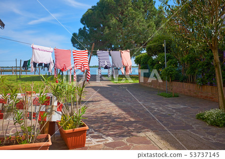 colorful gondolier shirts are drying in front of colorful gondolier shirts are drying in front of 53737145