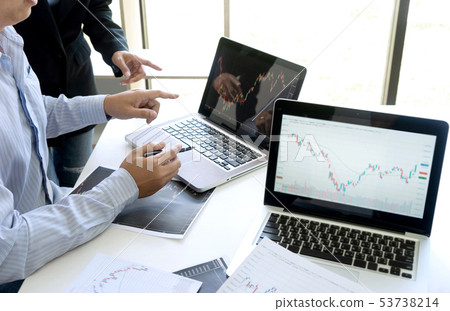 business man and woman sit at ther table looking 53738214