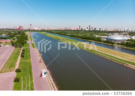Rowing canal illuminated by bright sunshine. Panoramic view. Shooting from above, aerial filming 53738268