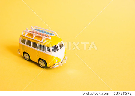 Funny yellow retro car with surfboard  53738572