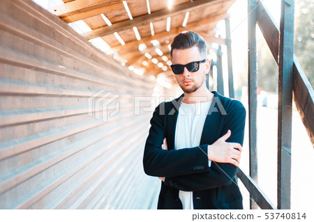 Young business man in sunglasses posing  53740814