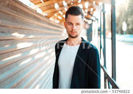 Handsome successful man in stylish clothes walking 53740822