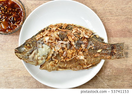 batter fried mango fish topping chop garlic 53741153