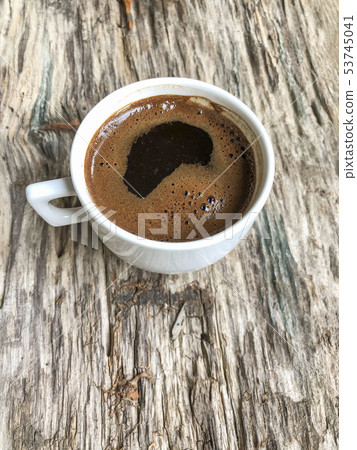 a cup of coffee on a wooden table a cup of coffee on a wooden table 53745041