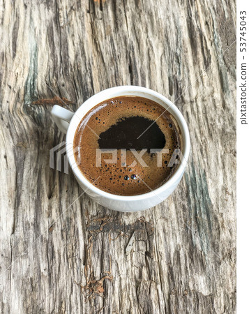 a cup of coffee on a wooden table a cup of coffee on a wooden table 53745043
