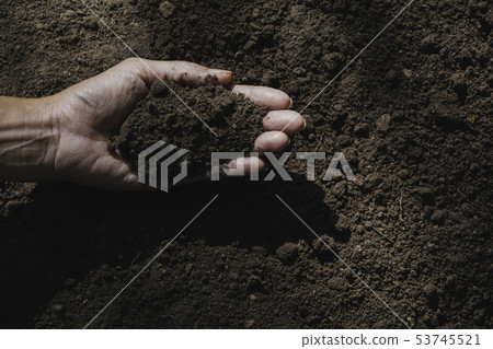 Hand of male holding soil in the hands for 53745521