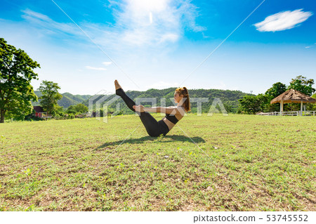 woman practice yoga boat pose or Navasana pose woman practice yoga boat pose or Navasana pose 53745552