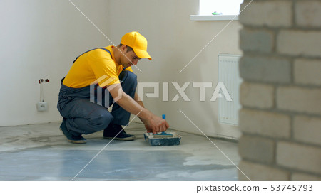 Builder processing concrete. 53745793