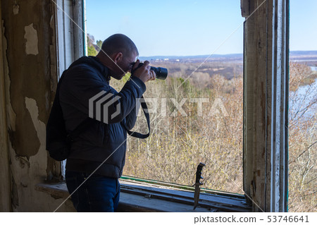 The photographer takes pictures from the window 53746641