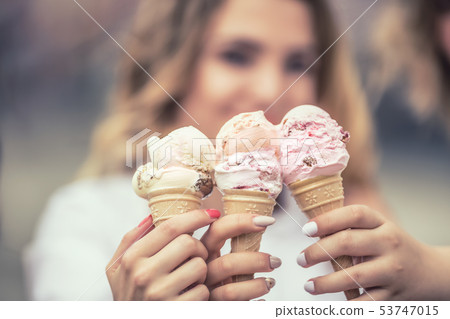 Delicious three ice cream in female hands - Delicious three ice cream in female hands - 53747015
