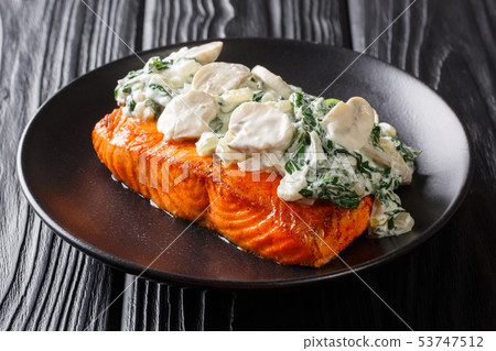 Organic baked salmon fillet topped with creamy Organic baked salmon fillet topped with creamy 53747512