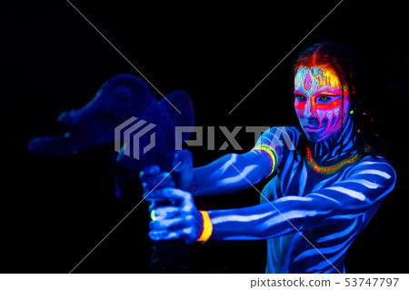 Portrait of Young naked bodyarted savage woman in blue glowing ultraviolet paint with primeval Portrait of Young naked bodyarted savage woman in blue glowing ultraviolet paint with primeval 53747797