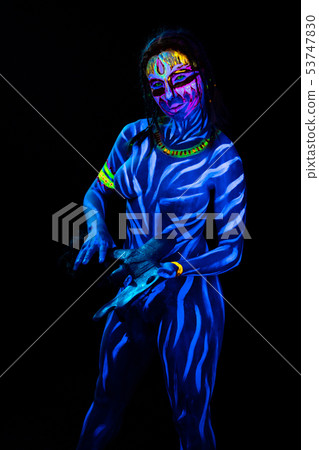 Portrait of Young naked bodyarted woman in blue glowing ultraviolet paint with tomahawk ancient Portrait of Young naked bodyarted woman in blue glowing ultraviolet paint with tomahawk ancient 53747830