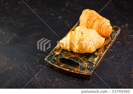 Freshly baked croissants on wooden cutting board, Freshly baked croissants on wooden cutting board, 53749360