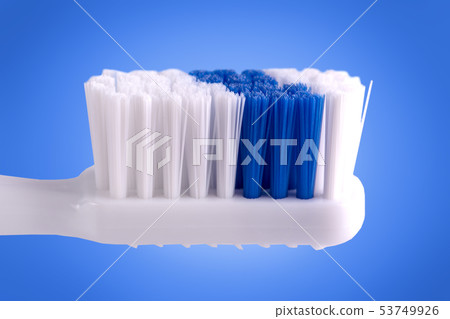 The toothbrush isolated on blue background The toothbrush isolated on blue background 53749926