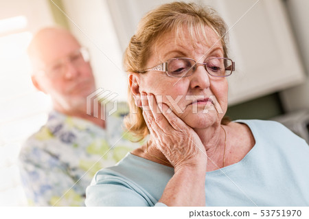 Senior Adult Man Standing Behind Sad Senior Adult Senior Adult Man Standing Behind Sad Senior Adult 53751970