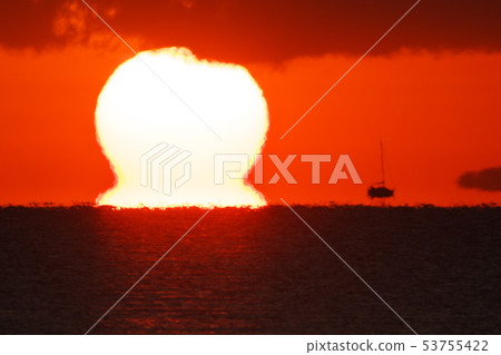 A sailboat floating in the air by the daruma sun and mirage 53755422