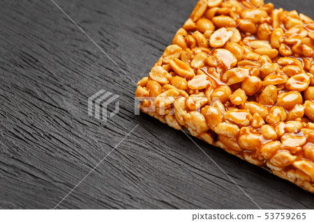 A large golden tile of peanuts, a bar in a sweet 53759265