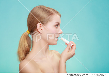 woman applying balsam for lips woman applying balsam for lips 53762076