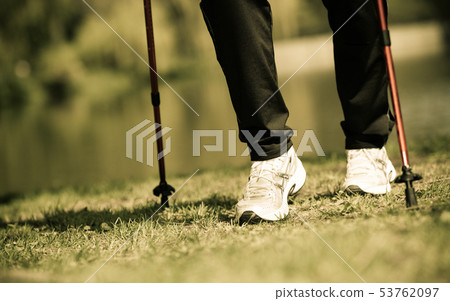 Nordic walking. Female legs hiking in the park. 53762097