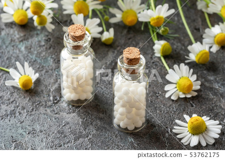Bottles of homeopathic pills with chamomile 53762175