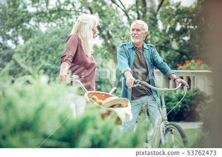 Positive bearded man walking with his bicycle Positive bearded man walking with his bicycle 53762473