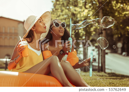 Profile portrait of arresting young blowing the bubbles off outdoors. Profile portrait of arresting young blowing the bubbles off outdoors. 53762649