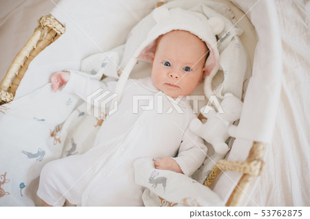 Baby in a straw basket Baby in a straw basket 53762875