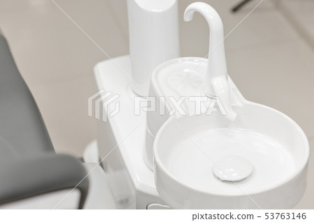 Closeup of a modern dentist tools. Drill tool in dental clinic. Medicine, health, stomatology Closeup of a modern dentist tools. Drill tool in dental clinic. Medicine, health, stomatology 53763146