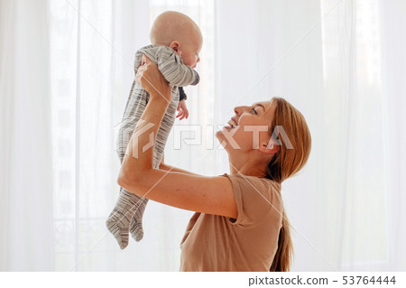 happy family mother playing with newborn baby happy family mother playing with newborn baby 53764444