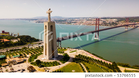 April of 25 bridge in Lisbon, crossing the Tagus River and Statue of Jesus 53766555