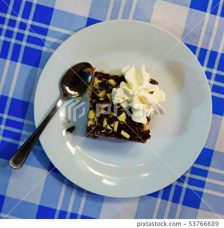 Sweet cake with chocolate and butter cream served at plate Sweet cake with chocolate and butter cream served at plate 53766689
