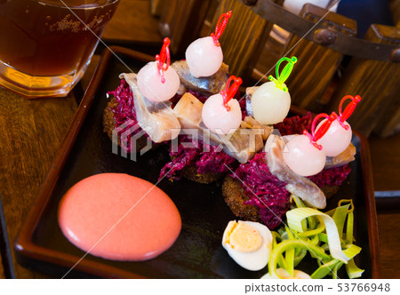 Canapes of pickled herring with beets Canapes of pickled herring with beets 53766948