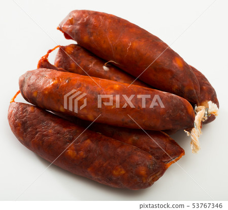 Sausages chorizo on white surface 53767346