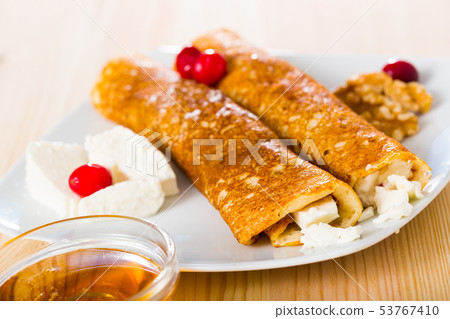 Bulgarian thin pancakes with brynza on white plate Bulgarian thin pancakes with brynza on white plate 53767410