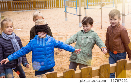 Happy kids playing blind man bluff 53767961