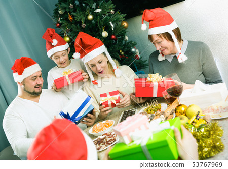 Cheerful family exchanging Christmas gifts 53767969
