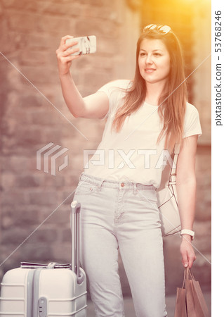 Young traveler walking the city and doing selfie Young traveler walking the city and doing selfie 53768246