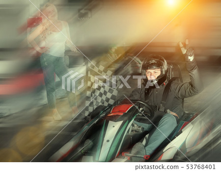 Male racer crossing finish line on kart track Male racer crossing finish line on kart track 53768401