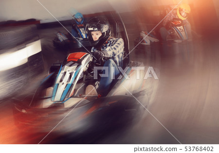 Young people driving sport cars for karting Young people driving sport cars for karting 53768402